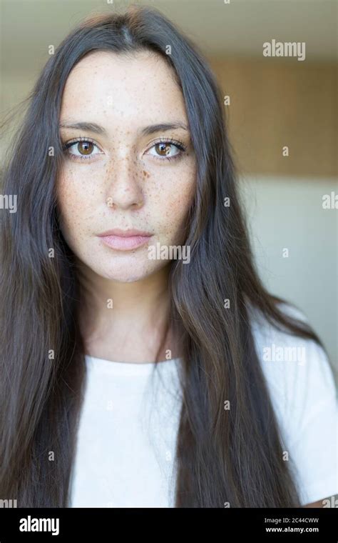 Close Up Portrait Of Beautiful Young Woman With Long Brown Hair At Home