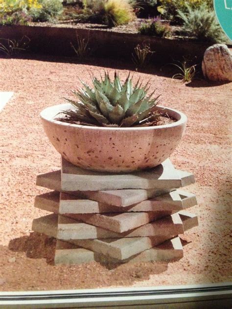 A Potted Plant Sitting On Top Of A Pile Of Blocks