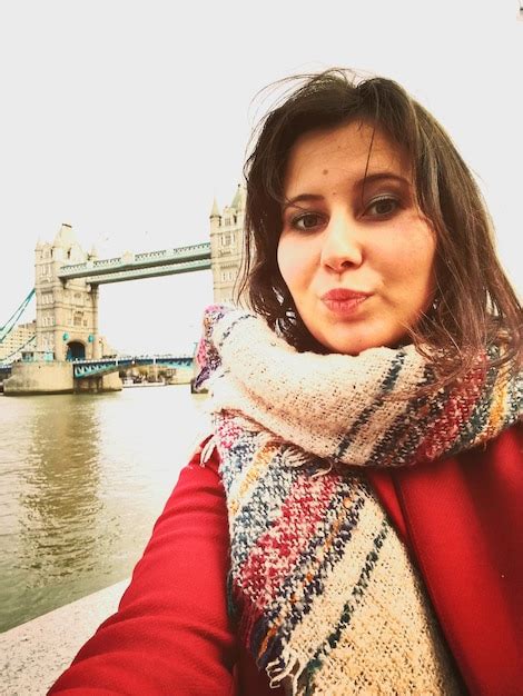 Premium Photo Portrait Of Woman Standing Against Tower Bridge Over