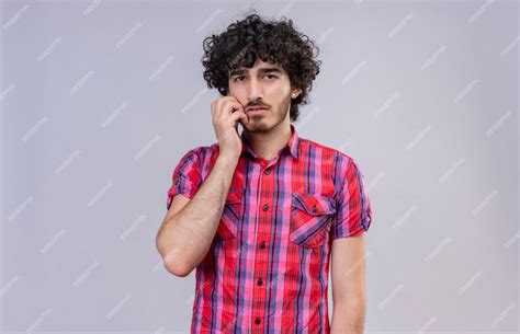 Free Photo A Thoughtful Handsome Man With Curly Hair In Checked Shirt