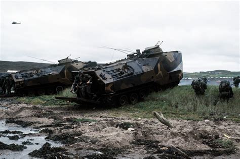 Combat Ready Marines Debark From Two LVTP 7 Tracked Landing Vehicles On