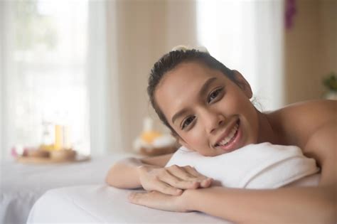 Premium Photo Portrait Of Young Woman Lying On Massage Table In Spa