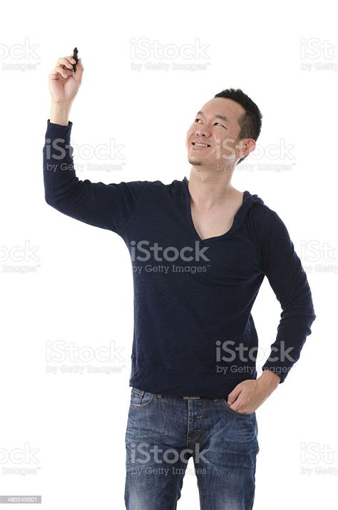 Asian Male Writing Something On Glass Board With Marker Stock Photo