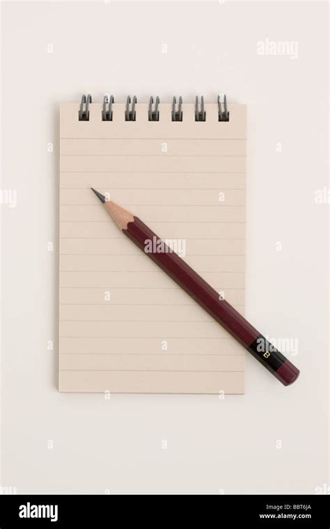 Spiral notepad with pencil Stock Photo - Alamy