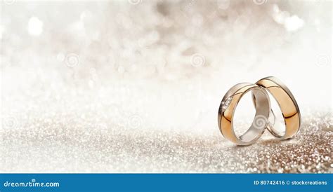 Two Gold Wedding Bands On Textured Glitter Stock Photo Image Of