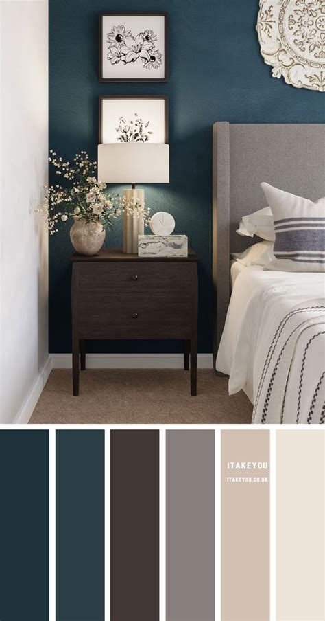 A Bedroom With Blue Walls White Bedding And Gray Furniture In The