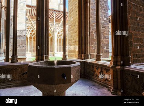 The Holy Water Stoup In The Ornate Gothic Cloister Arcade Arches Of The