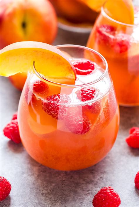 Peach Rosé Sangria in stemless glass garnished with a peach slice