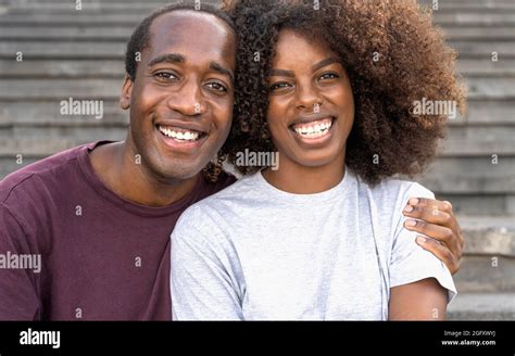 Happy African Couple Having Fun Smiling Into The Camera While Sitting