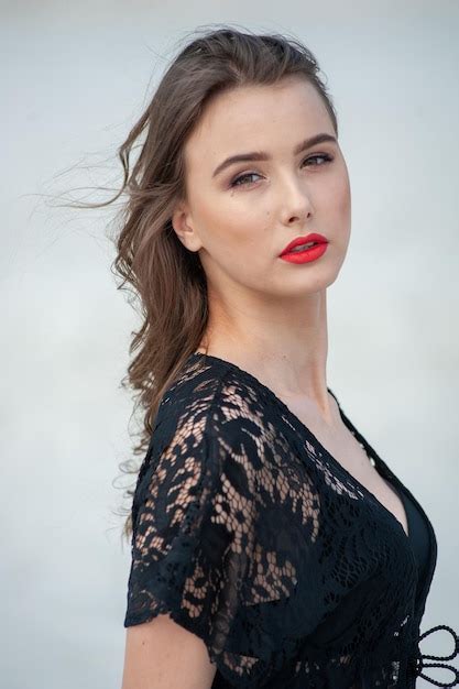 Premium Photo A Woman With Long Brown Hair And Red Lipstick Looks