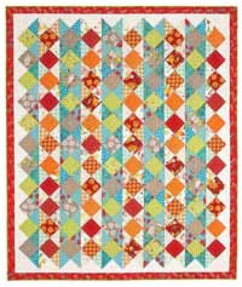 A Colorful Quilt With Many Different Colors And Patterns On The Front