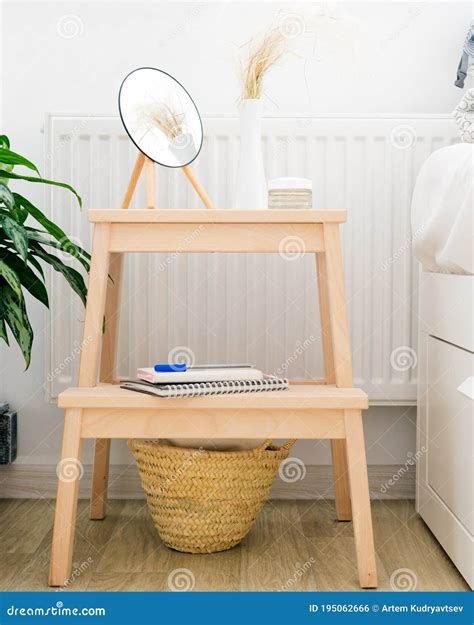 Bedside Table With A Small Round Mirror Face Cream In A White Interior