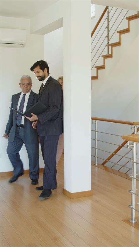 real estate agent showing  house   couple  stock video