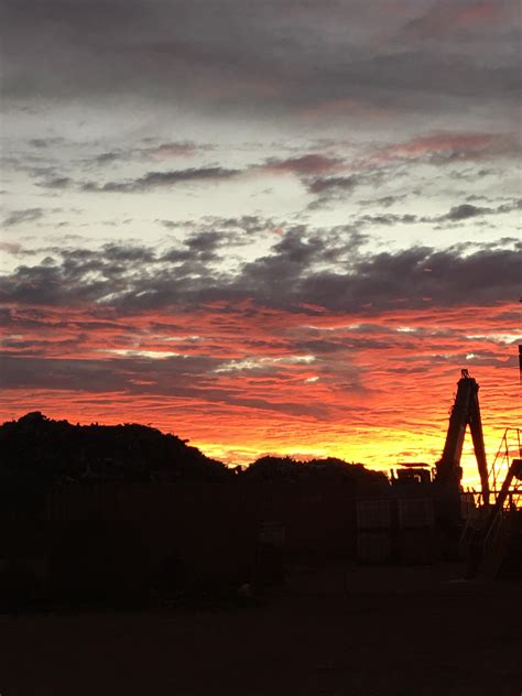 Sunrise over a metal scrap yard looks like something out of wall-E : r