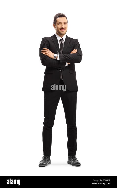 Full Length Portrait Of A Busniessman Wearing A Black Suit And Posing