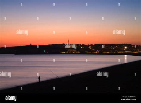 Sunset behind Newhaven, from Seaford beach, Sussex, England, UK Stock Photo - Alamy