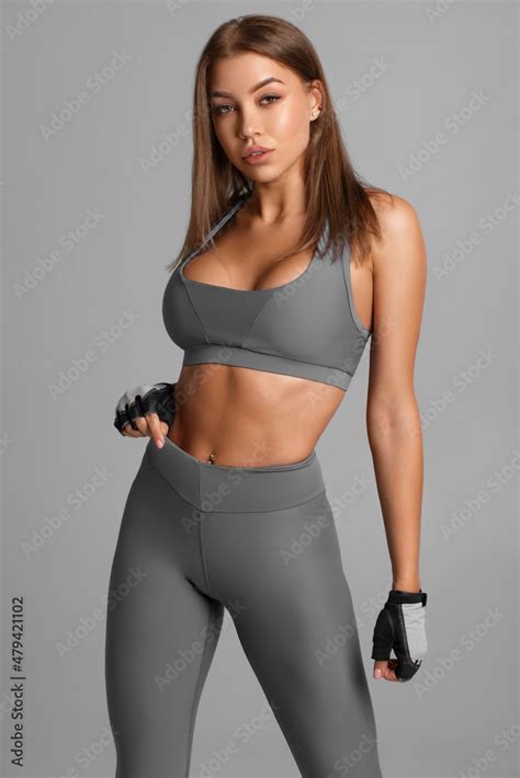 Beautiful fitness woman. Athletic girl on the gray background Stock ...