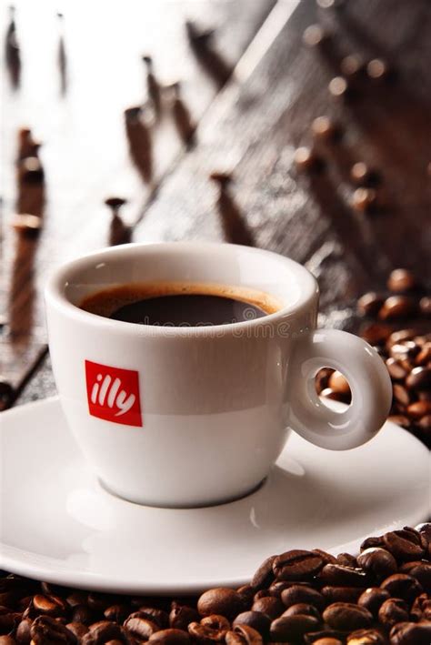 Composition With Cup Of Illy Coffee And Beans Editorial Stock Image