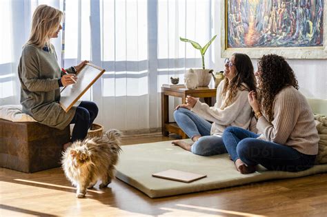 Female Patients Laughing During Motivation Session With Therapist At