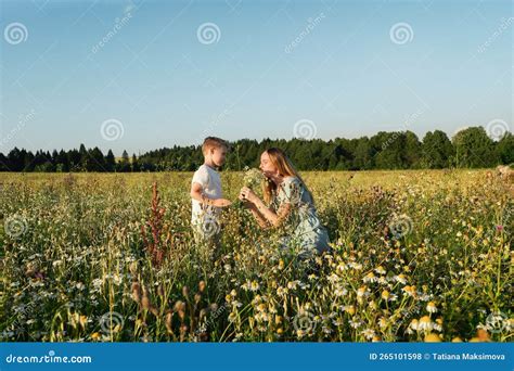 The Son Gives Flowers To His Mother. Stock Photo - Image of childhood, smile: 265101598