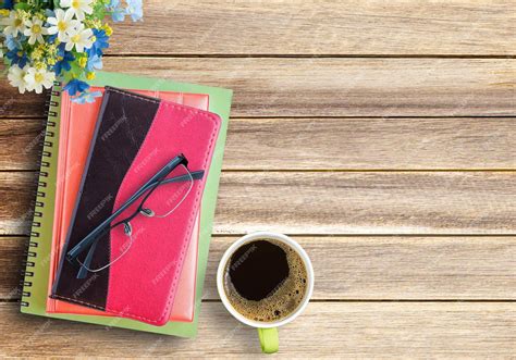 Premium Photo Coffee Cup And Books With Glasses On Brown Wood Table Backgroundt