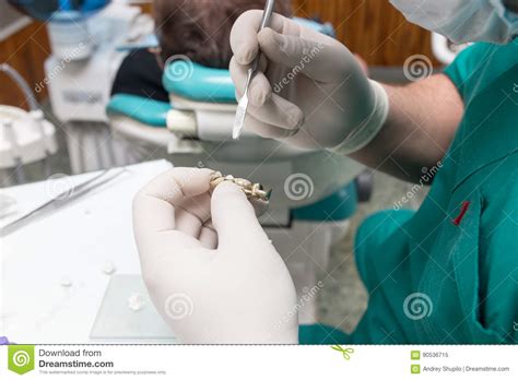 A Dentist Prepares An Implant In The Clinic Stock Image Image Of