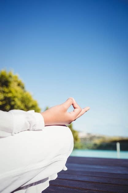 Premium Photo Calm Brunette Doing Yoga By The Pool