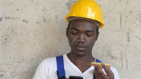 Hungry Afro American Worker At Construction Site Eating Sandwich Lunch