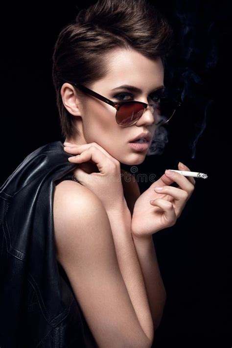 Fashion Model Smoking Cigarette Wearing Sunglasses Woman Portrait Over Dark Background