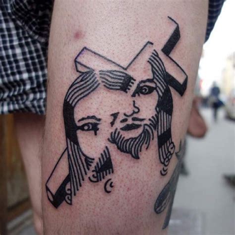 Original black ink cross with Jesus tattoo on leg - Tattooimages.biz