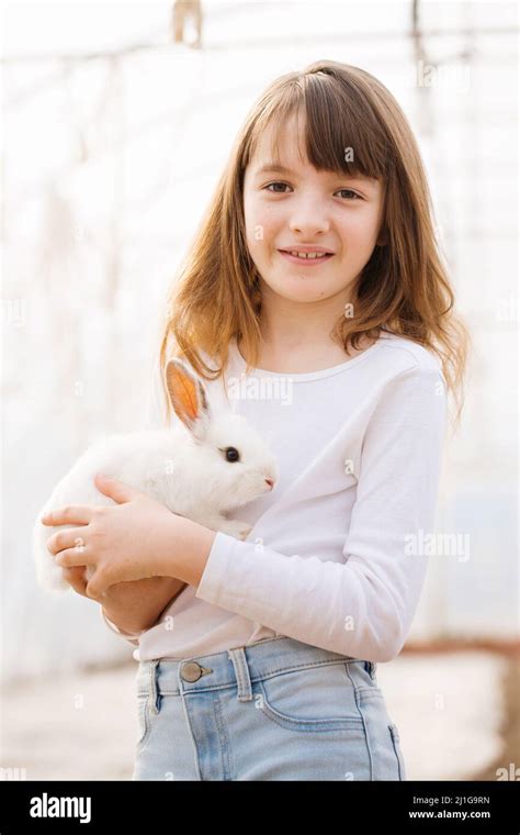 Portrait Of A Girl In White With A White Rabbit In Her Hands Easter