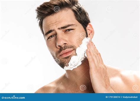 Photo Of Brutal Half Naked Man Applying Shaving Foam On His Face Stock