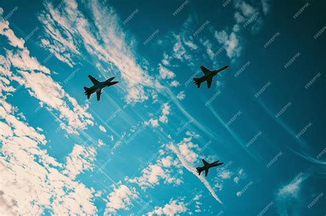 Premium Ai Image A Group Of Fighter Jets Flying Through A Blue Sky