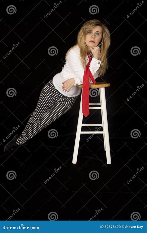 Female Model Leaning On A Bar Stool Looking At Camera Stock Photo