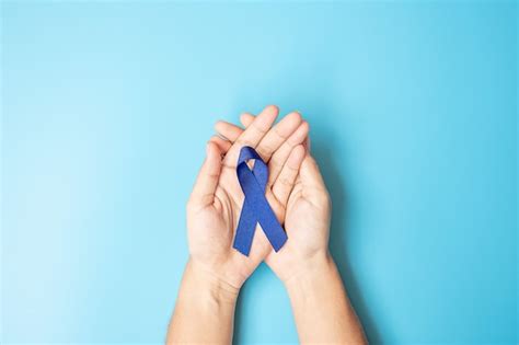 Premium Photo Man Holding Red Ribbon For Supporting People Living And