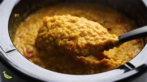 A Ladle Full Of Soup In A Slow Cooker