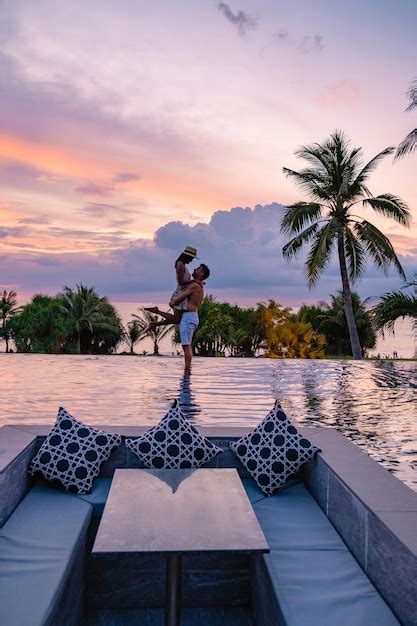 Premium Photo Couple Watching The Sunset In An Infinity Pool On A Luxury Vacation In Thailand