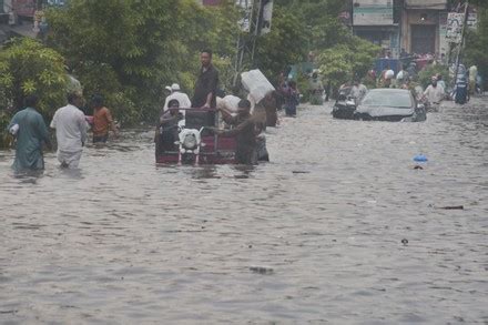 Pakistani Commuters Wade Through Flooded Road Editorial Stock Photo