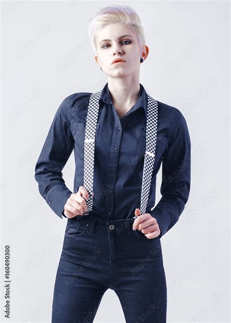 Elegant Girl In Black Shirt And Black Jeans With Suspenders On White