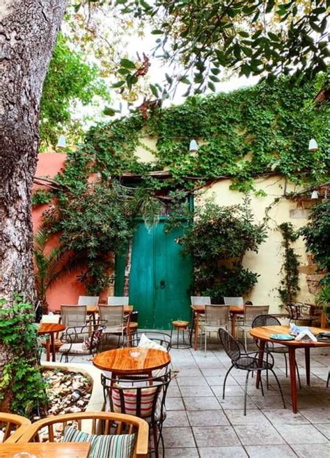 An Outdoor Dining Area With Tables And Chairs