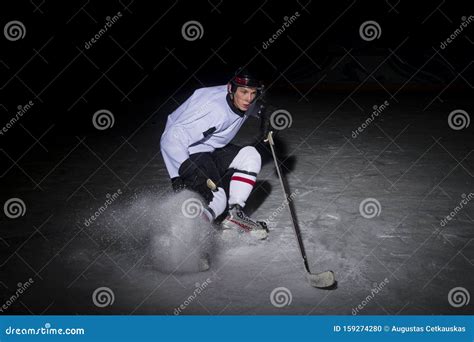 Ice Hockey Player In Action Kicking With Stick Stock Photo Image Of