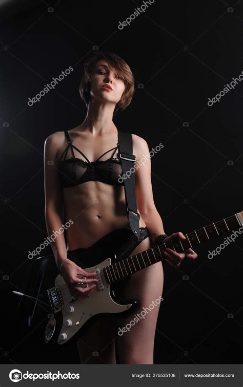 Beautiful Sexy Girl With Electric Guitar On A Black Background Stock