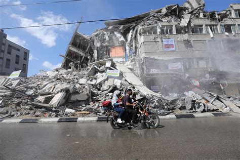 Palestinian Volunteers Sweep The Rubble Of Buildings Destroyed By