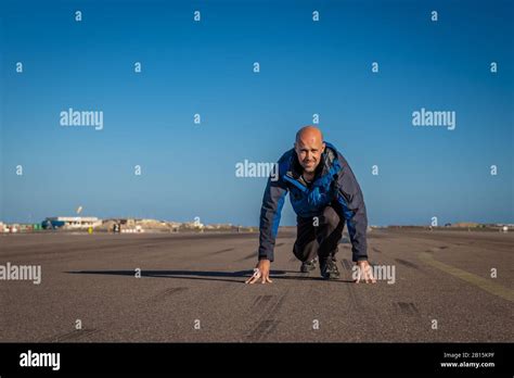 man running on the runway at the airport Stock Photo - Alamy