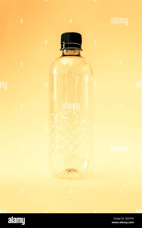 An Empty Generic Single Use Plastic Water Bottle On A Yellow Background