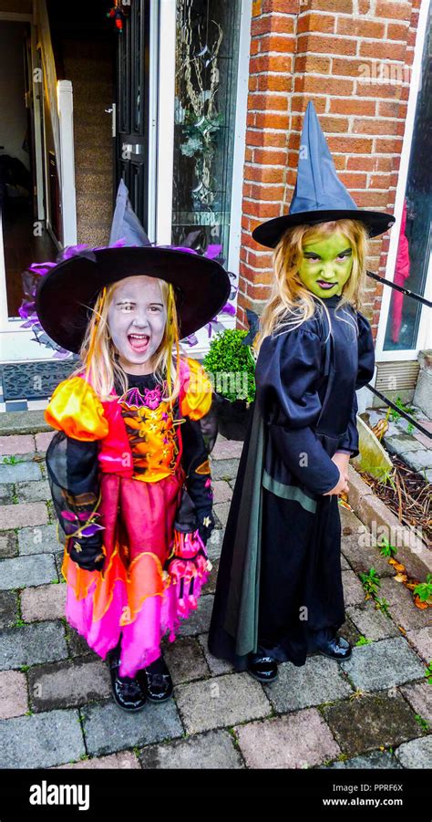 Little Girls Children Dressed In Witches Halloween Costume Wearing