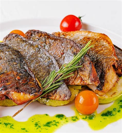 Premium Photo Fried Fish With Vegetables On Plate