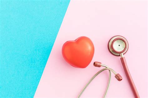 Premium Photo Top View Red Stethoscope And Red Heart Shape On Pink