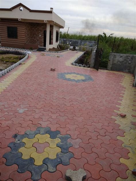 a red and yellow brick walkway leading to a house