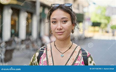 Young Beautiful Hispanic Woman Standing With Serious Expression At